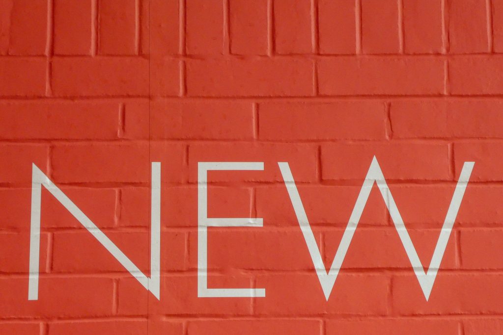 Header image: the word NEW on a red brick wall