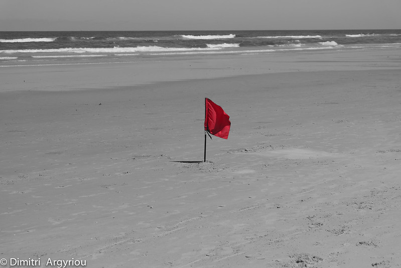 Header image: a red flag flying on a beach (credit: Dimitri Argyriou)