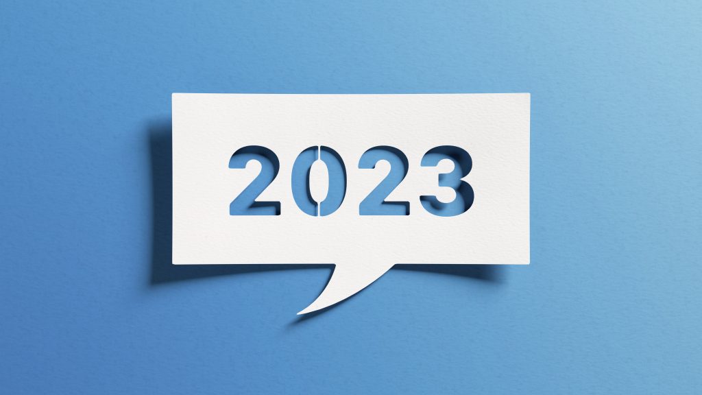 Header image: White paper dialog box with 2023 cut out stencil-style, on a blue background (credit: NicoElNino / Shutterstock.com)
